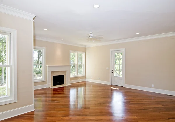 Custom Wooden Floors installation showing precise cuts around walls, corners, and fixtures