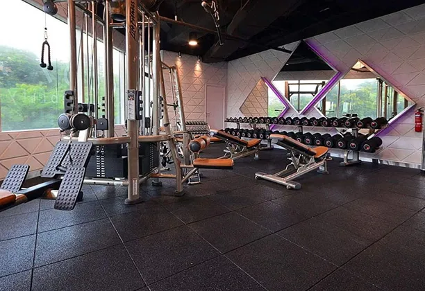 Gym flooring designed for durability and safety, featuring a textured surface ideal for fitness environments.
