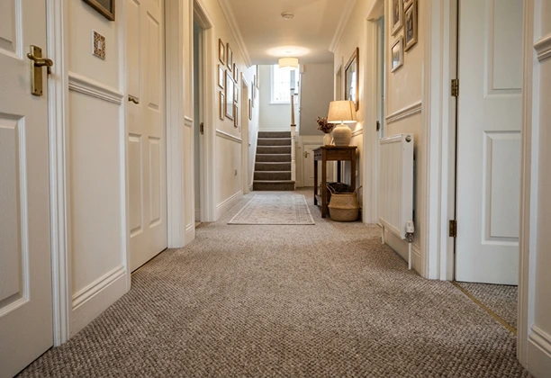 Hallway Carpet Flooring with patterned pile texture installed along residential corridor walkway