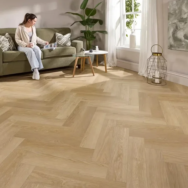 Herringbone-style LVT arranged in a classic zigzag pattern across a residential living room floor