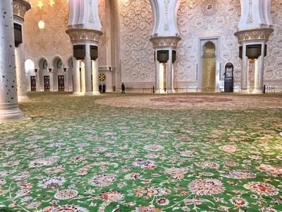 Mosque Carpet Dubai being measured and fitted by installers to match the layout of a mosque interior