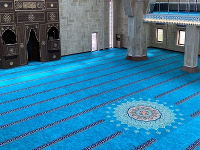 Mosque Carpet Dubai showing completed wall-to-wall flooring with uniform prayer lines inside a mosque hall