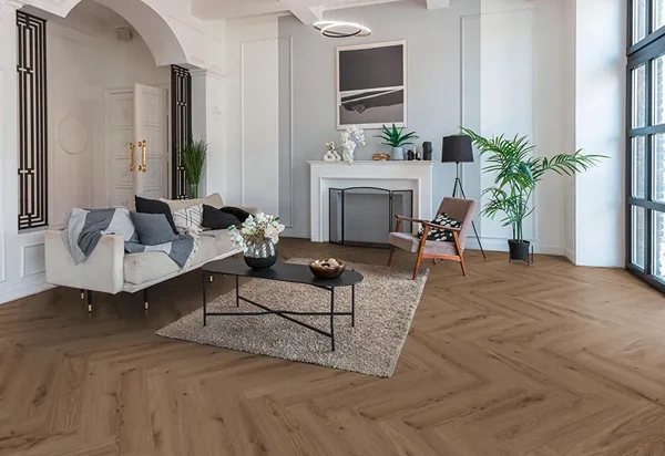Professional herringbone SPC flooring installation featuring a unique zigzag pattern, elegant design, and durable finish for modern interiors.