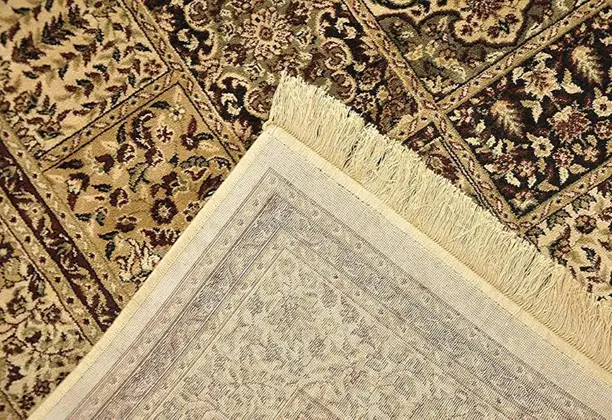 Silk Carpet with detailed woven patterns displayed in a modern living room with wooden flooring