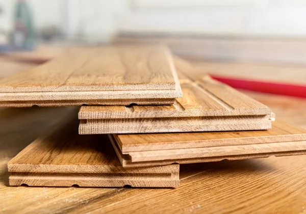 Solid Hardwood Flooring installation showing precise plank fitting over a prepared subfloor
