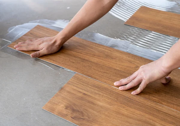 Vinyl Flooring Installation in progress with accurate cutting around walls and door frames
