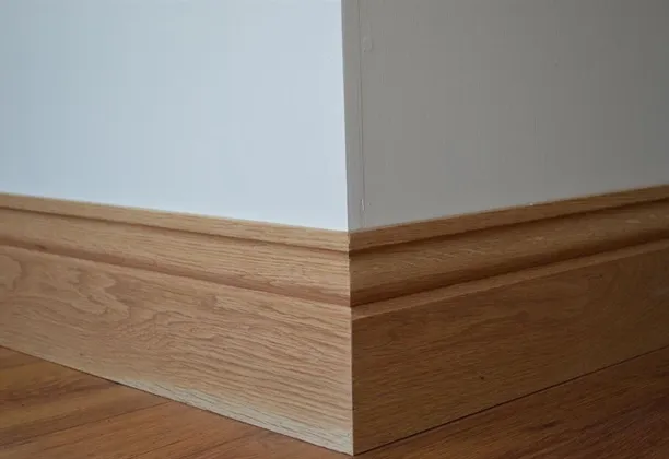 Wall Skirting installed along the base of a living room wall with a clean edge between flooring and painted surface