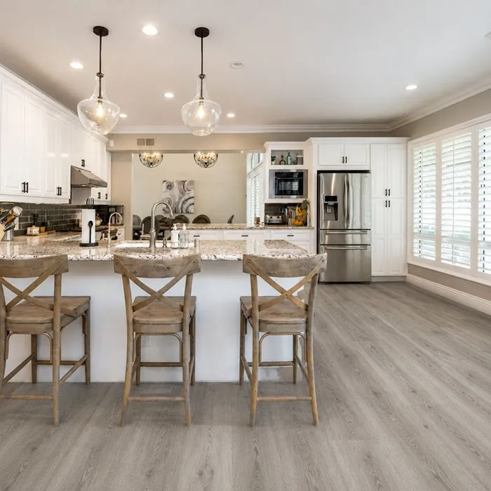 Waterproof SPC vinyl flooring installed with durable surface protection, suitable for kitchens, bedrooms, and living areas.