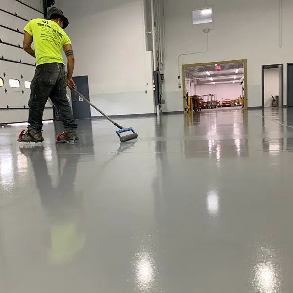 Protective epoxy topcoat applied during the floor curing process